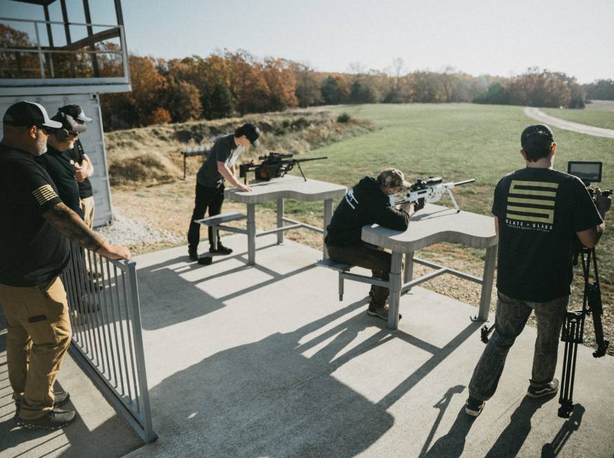 Two marksmen shooting long range with ai ballistic support.